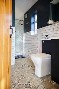 a bathroom with a toilet and a sink at Brand new purpose built annex :- The Stables in Halifax