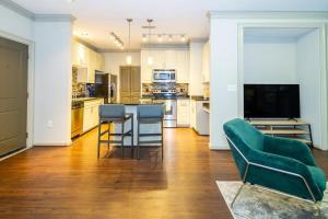a kitchen with a couch and a table with chairs at Landing - Modern Apartment with Amazing Amenities (ID3752) in Atlanta