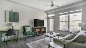 a living room with a couch and a tv at Landing - Modern Apartment with Amazing Amenities (ID6167X30) in Richmond