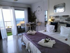 a hotel room with two beds with towels on them at Playa Monis 1 in Icod de los Vinos