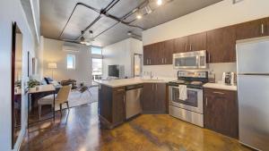 a large kitchen with wooden cabinets and a dining room at Landing - Modern Apartment with Amazing Amenities (ID7845X46) in Sparks