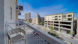 a balcony with a view of a city with buildings at Landing - Modern Apartment with Amazing Amenities (ID7845X46) in Sparks
