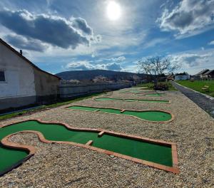 a row of miniature golf greens on a gravel road at Zsindely Ház Károlyfalva Sátoraljaújhely in Sátoraljaújhely