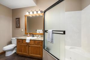 a bathroom with a toilet and a sink and a shower at Deer Valley in Branson