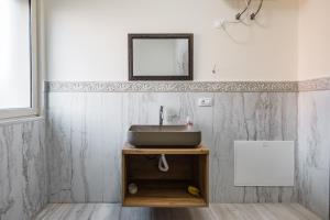 a bathroom with a sink and a mirror at The Urban Villa in Shkodër