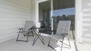 two chairs and a table on a porch at Landing - Modern Apartment with Amazing Amenities (ID1374X806) in Charlotte