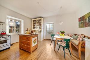 a kitchen and living room with a table and chairs at APARTMENT im garten 9 in Gargazzone