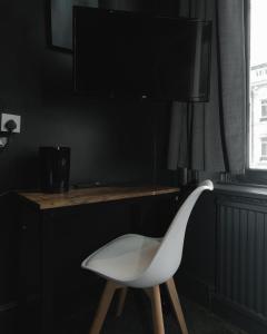 a white chair sitting in front of a table at Amsterdam Hotel in London