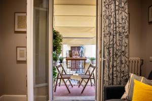 a living room with a table and chairs outside a door at Smooth Mansion in Ponte Vecchio in Florence