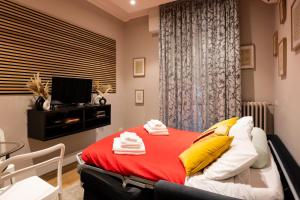 a bedroom with a bed with a red blanket at Smooth Mansion in Ponte Vecchio in Florence