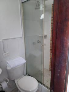a bathroom with a toilet and a glass shower at Room in Guest room - Cerca A Corferias Y Embajada Americana in Bogotá