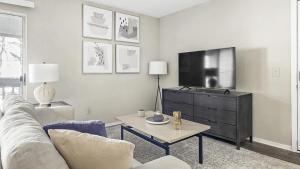 een woonkamer met een bank en een flatscreen-tv bij Landing - Modern Apartment with Amazing Amenities (ID1182X728) in College Park