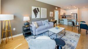 a living room with a couch and a table at Landing - Modern Apartment with Amazing Amenities (ID4177X58) in Owings Mills