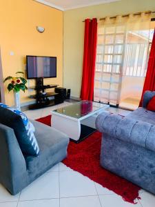 a living room with a couch and a coffee table at Yonga Apartment in Kisumu