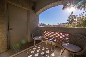 a balcony with two chairs and a table and a door at Landing - Modern Apartment with Amazing Amenities (ID1793X49) in Phoenix