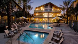 a swimming pool with chairs and a building at The tulip Marina Highrise with ocean view in Los Angeles