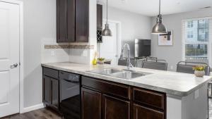 a kitchen with a sink and a counter at Landing - Modern Apartment with Amazing Amenities (ID8193X50) in Columbus