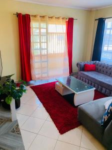 a living room with a couch and a coffee table at Yonga Apartment in Kisumu