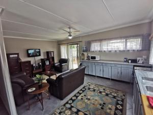 a living room with a couch and a table at Feather Rest in Bloemfontein