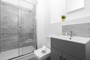 y baño con ducha, lavabo y aseo. en Modern Apartment - Twin Beds - Free Netflix & Wifi - Parking - Top Rated - 7OC, en Brierley Hill