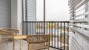 a balcony with a table and chairs and a view of a pool at Landing - Modern Apartment with Amazing Amenities (ID8375X72) in Middleburg