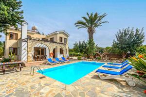 a villa with a swimming pool in front of a house at Villa Irene Polis in Polis Chrysochous