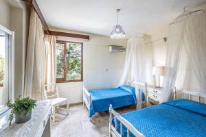 a bedroom with two beds and a window at Villa Irene Polis in Polis Chrysochous