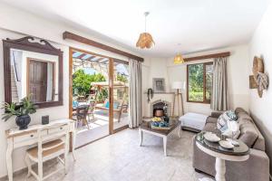 a living room with a couch and a table at Villa Solon in Polis Chrysochous