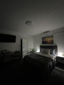 a bedroom with a bed and a table and a desk at LuxRooms BJELOVAR in Bjelovar