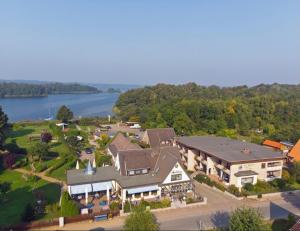 an aerial view of a large house with a lake at Haus Schwanensee, Wohnung 9 in Bosau