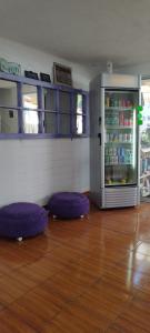 a room with purple ottomans in front of a refrigerator at Shalom_MatSofy in Santiago