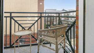 a chair and a table on a balcony at Landing - Modern Apartment with Amazing Amenities (ID1285X345) in Greensboro