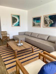 a living room with a couch and a coffee table at Casa Z Paracas in Paracas