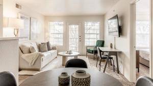 a living room with a couch and a table at Landing - Modern Apartment with Amazing Amenities (ID9354X35) in Albuquerque