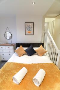 a bedroom with a bed with two pillows on it at New- Modern 2br Apt Wifi Sleep5 City Centre in Sheffield
