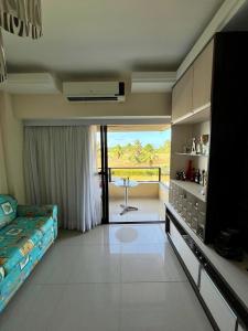 a living room with a bed and a table in it at Gavoa Resort Flat - Mar Doce Lar in Igarassu +14 photos