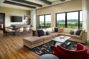 a living room with a couch and a table at SpringHill Suites by Marriott Franklin Mint in Franklin