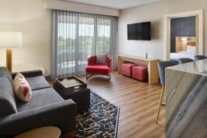 a hotel room with a couch and a bed at SpringHill Suites by Marriott Franklin Mint in Franklin
