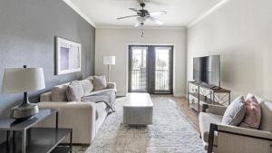 a living room with a couch and a tv at Landing - Modern Apartment with Amazing Amenities (ID7367X45) in Jacksonville