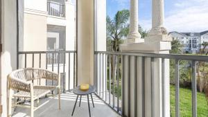 a balcony with a chair and a table at Landing - Modern Apartment with Amazing Amenities (ID7367X45) in Jacksonville