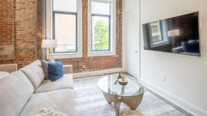 a living room with a couch and a table at Landing - Modern Apartment with Amazing Amenities (ID5790X33) in Birmingham +6 photos