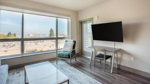 a living room with a desk and a large window at Landing - Modern Apartment with Amazing Amenities (ID2499X88) in San Jose