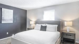 a bedroom with a white bed with two night stands at Landing - Modern Apartment with Amazing Amenities (ID9303X46) in Lewis Center