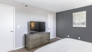 a bedroom with a bed and a flat screen tv at Landing - Modern Apartment with Amazing Amenities (ID9303X46) in Lewis Center