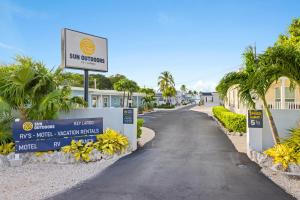 a street with a sign in front of a building at Sun Outdoors Key Largo in Key Largo