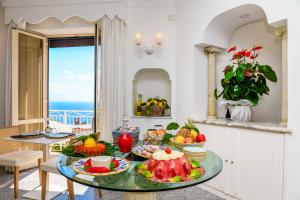 una cucina con tavolo e frutta di Residenza Al Pesce D'Oro ad Amalfi