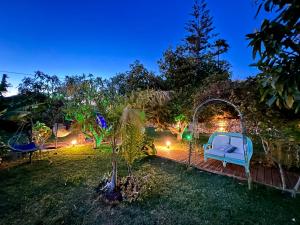 a garden at night with a blue bench and lights at Hotel Altea Paradise 1917 - Adults Only in Altea