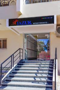 a set of stairs in front of a building with a sign at Lazur Hotel Apartments in Hurghada