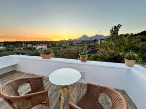 a table and two chairs on a balcony with the sunset at Hotel Altea Paradise 1917 - Adults Only in Altea