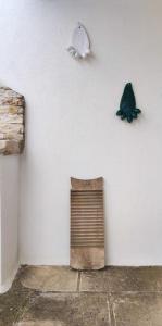 a white wall with a butterfly on the wall at Casa Mea in Grottaglie +42 photos